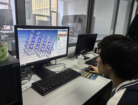 Daniel examining a MOF molecular-structure model