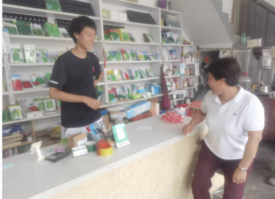 Daniel interviewing an agri-supply store owner in Lanling