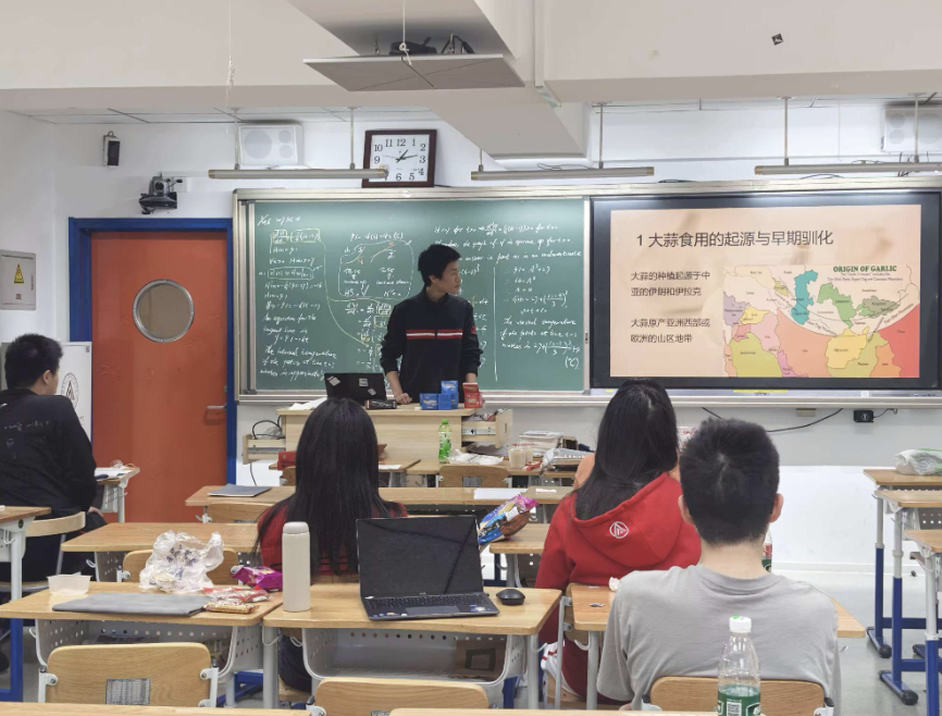 Daniel lecturing on garlic culture, chemistry, and agriculture